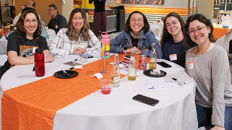 group of 5 female faculty sitting at a table at Faculty Pub event