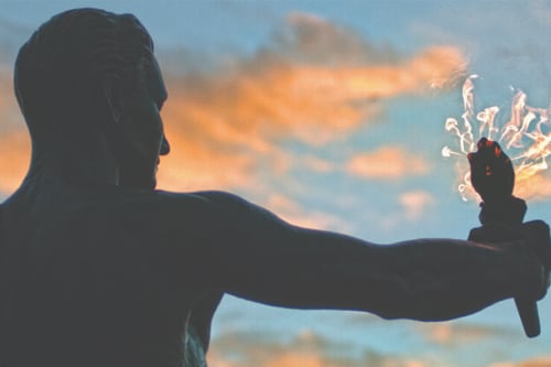 Torchbearer statue with sunset in the background