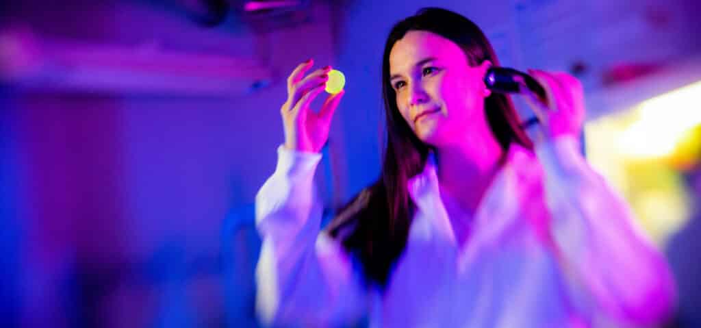 A student examines samples in the Scintillation Materials Research Center