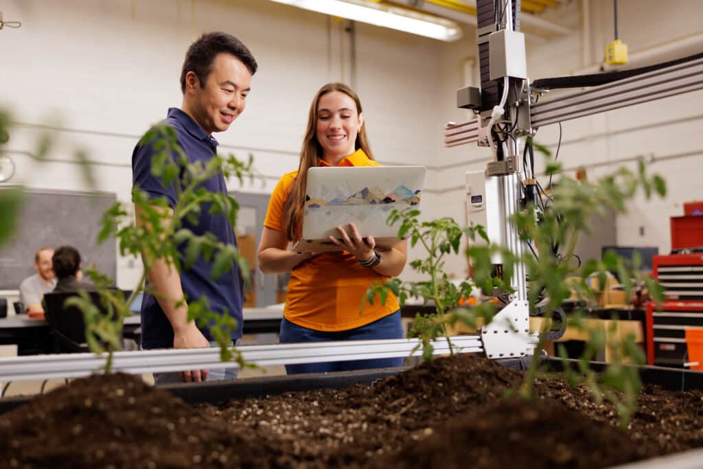Researchers take data on plants with a farm bot in the Smart Agriculture Lab.