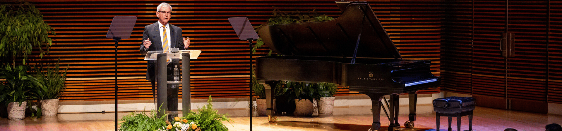 Provost and Senior Vice Chancellor speaking at a podium in the Natalie L. Haslam College of Music