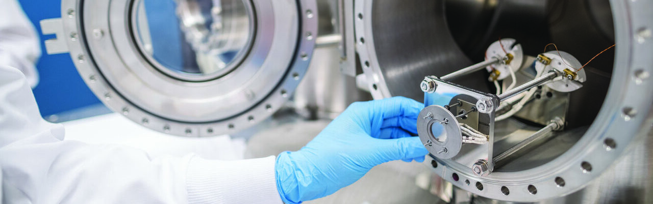 close-up of gloved hand working with equipment in nuclear engineering lab